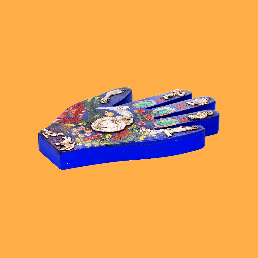 Wooden hand with Milagros
