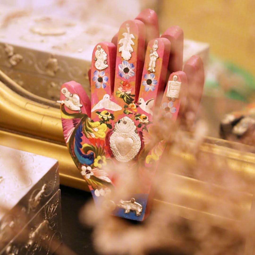 Wooden hand with Milagros