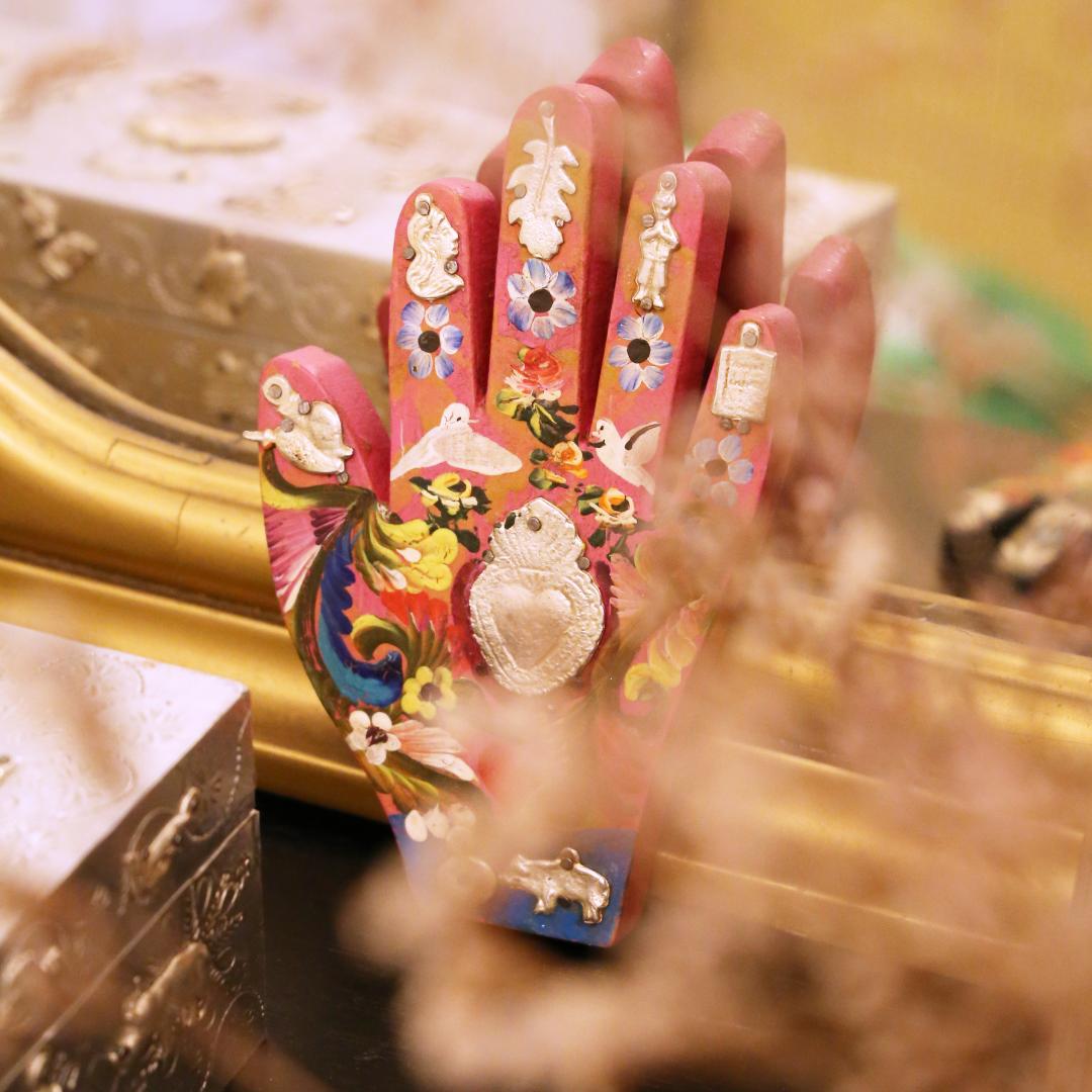 Wooden hand with Milagros